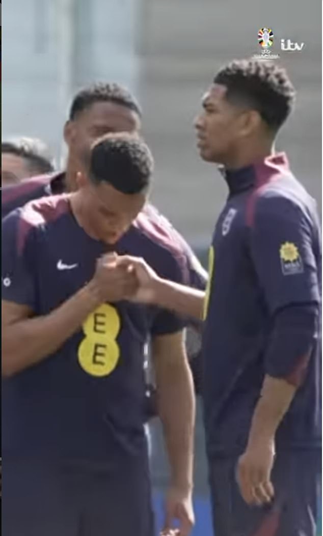 Alexander-Arnold and Bellingham appear to blow on each others hand during the handshake