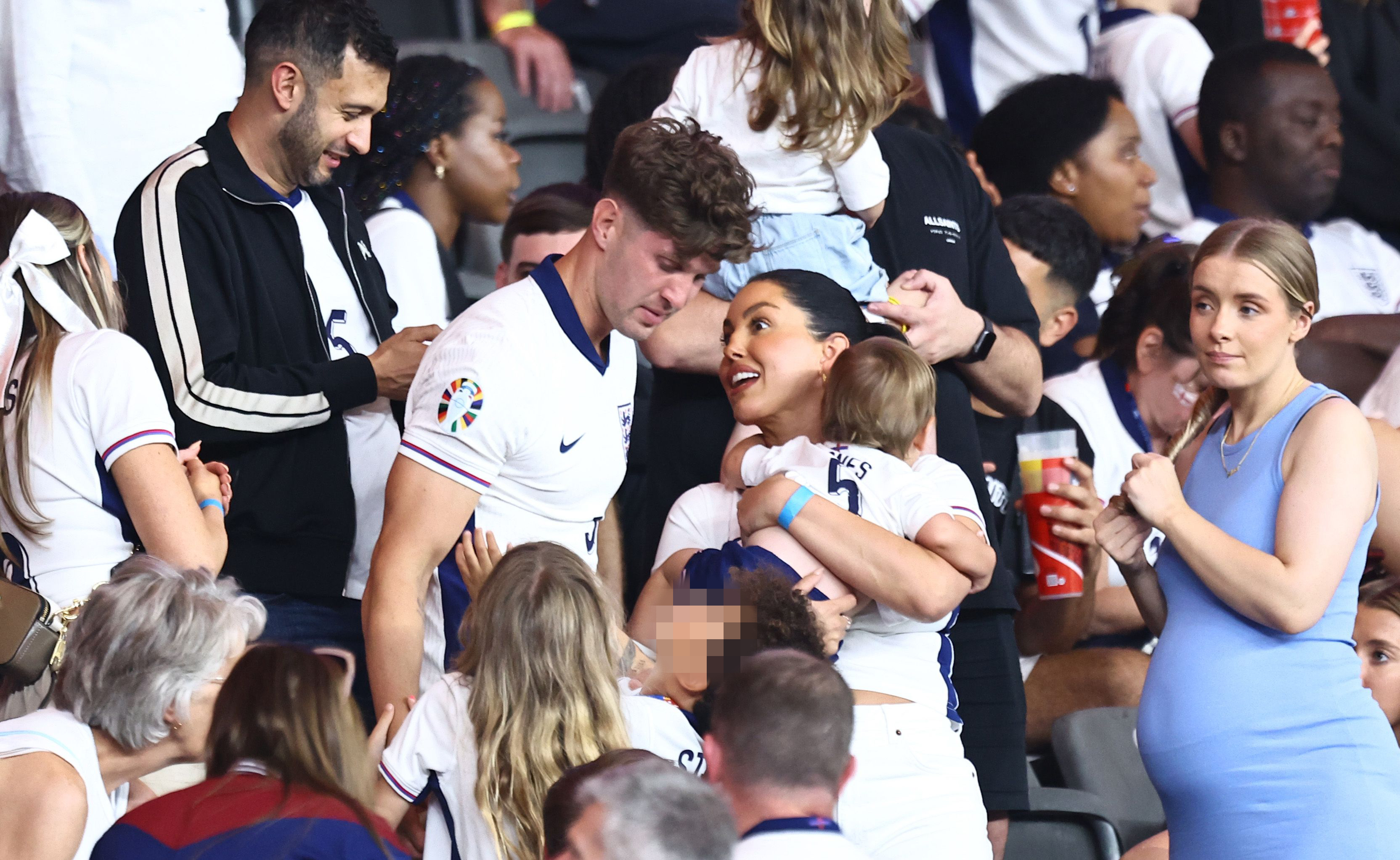 John Stones is consoled by Olivia Naylor and their son after the defeat