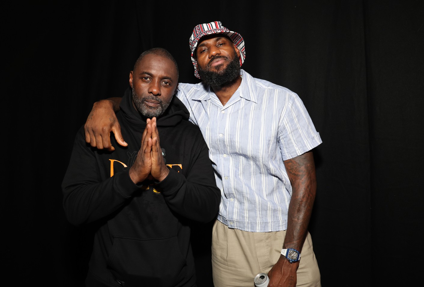 The basketball superstar wore a bucket hat as he posed with Elba